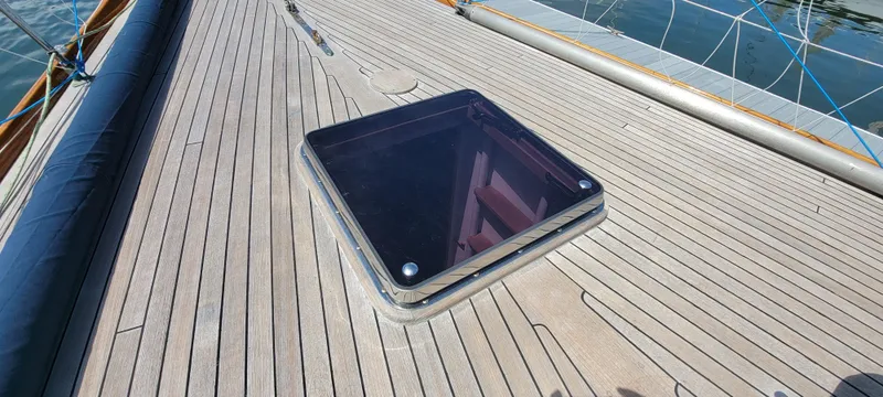 Slide: The Image of The deck of a sailboat with a square hatch. - 11