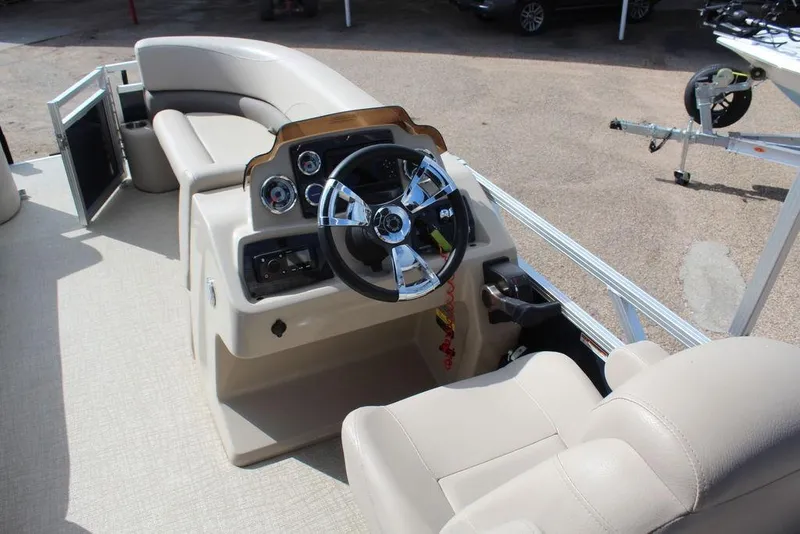 Slide: The Image of 2021 Avalon VLS Quad Lounge 22 FT boat interior with steering console and seating. - 12