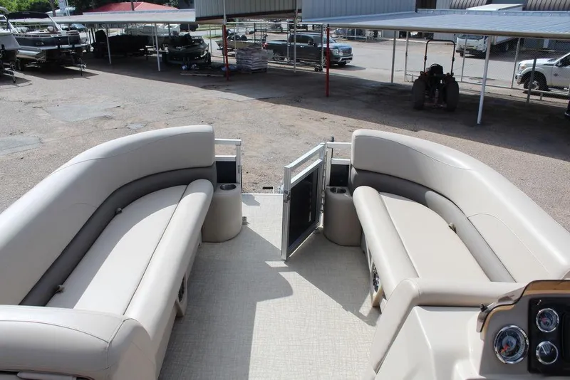 Slide: The Image of 2021 Avalon VLS Quad Lounge 22 FT interior with beige seating and open gate. - 15