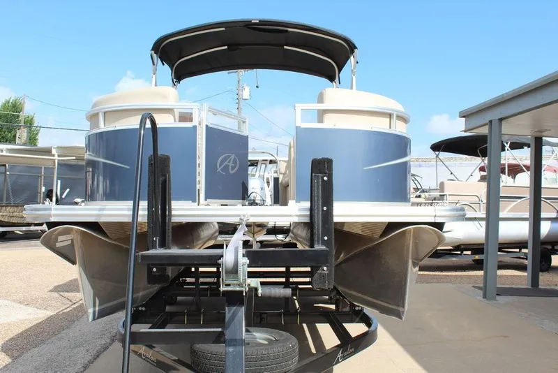 Slide: The Image of 2021 Avalon VLS Quad Lounge 22 FT pontoon boat on trailer, front view. - 5