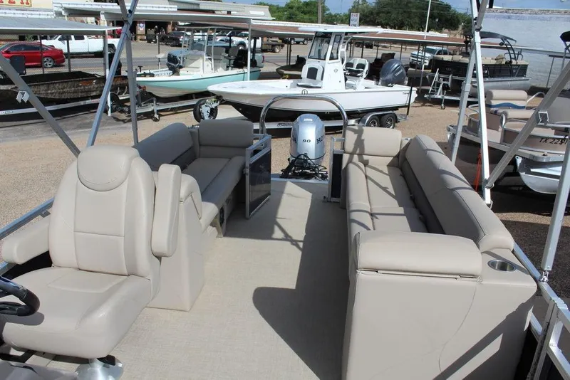 Slide: The Image of 2021 Avalon VLS Quad Lounge 22 FT pontoon boat with beige seating and Honda motor. - 18