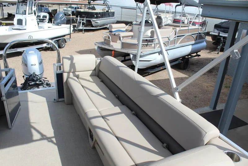 Slide: The Image of 2021 Avalon VLS Quad Lounge 22 FT pontoon boat with beige seating and Honda outboard motor. - 16
