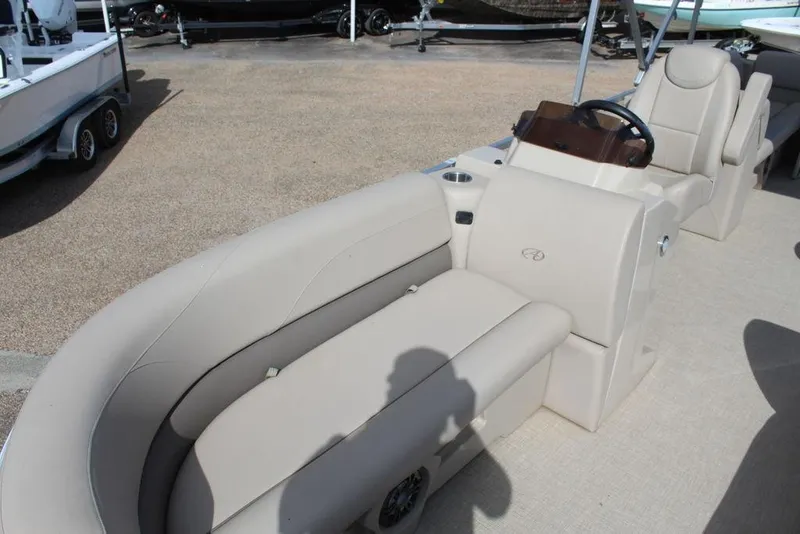 Slide: The Image of 2021 Avalon VLS Quad Lounge 22 FT boat interior with beige seating and steering console. - 7