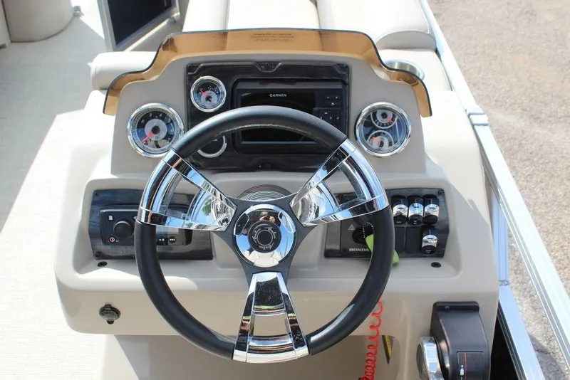 Slide: The Image of Steering console of 2021 Avalon VLS Quad Lounge 22 FT boat with gauges and controls. - 19