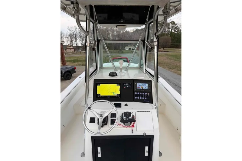 Slide: The Image of 2000 Regulator 26 Forward Seating boat dashboard with navigation equipment and steering wheel. - 7
