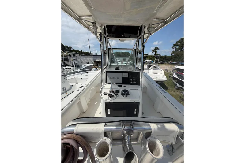Slide: The Image of 2000 Regulator 26 Forward Seating boat interior with steering wheel and Garmin navigation system. - 6