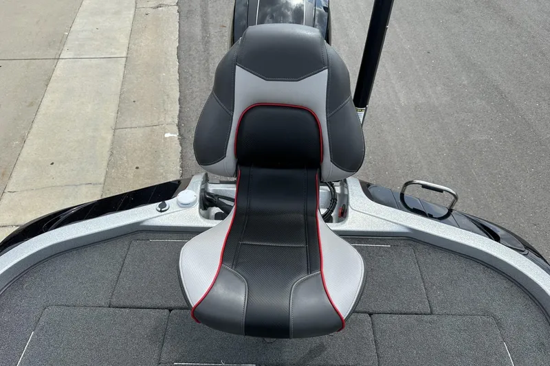 Slide: The Image of 2018 Ranger Z518 boat seat with black, gray, and red accents on a textured deck. - 26