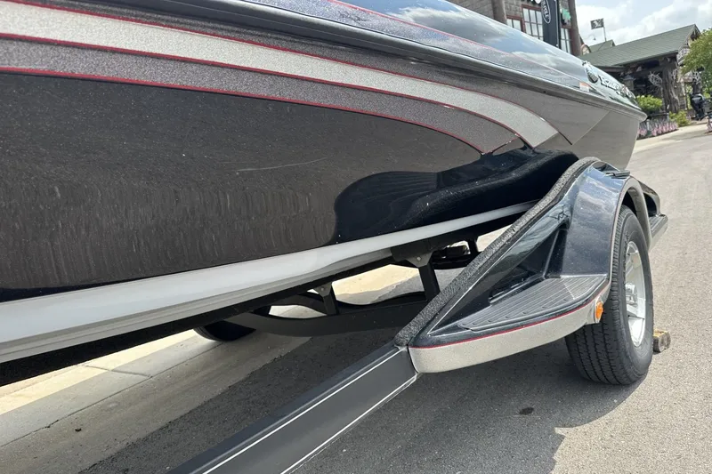 Slide: The Image of 2018 Ranger Z518 boat on trailer, showcasing sleek black and silver design. - 2