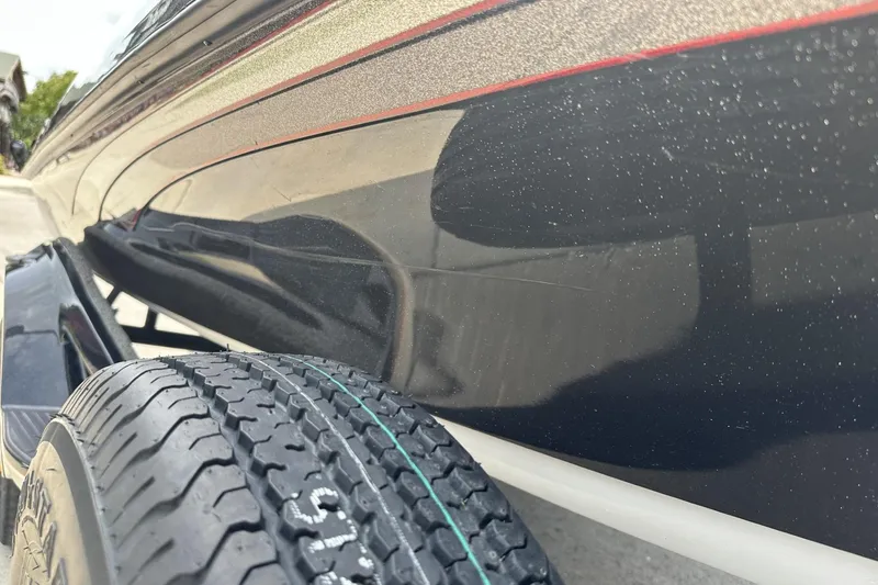 Slide: The Image of 2018 Ranger Z518 boat close-up showing hull and trailer tire detail. - 13