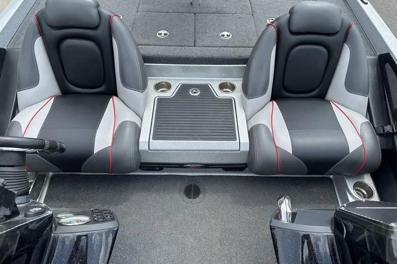 Slide: The Image of 2018 Ranger Z518 boat interior with dual black and gray seats, featuring red accents. - 18