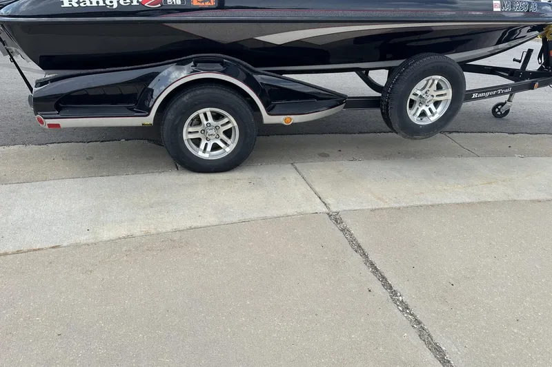 Slide: The Image of 2018 Ranger Z518 boat on trailer, parked on concrete surface. - 12
