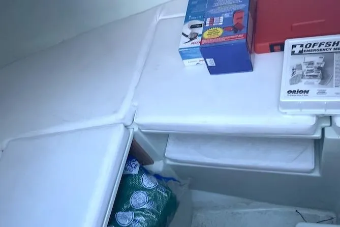 Slide: The Image of Interior of a 2002 Intrepid 323 Cuddy with emergency kit and supplies. - 5