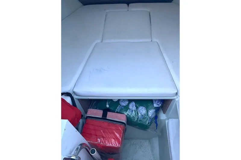 Slide: The Image of Interior cabin of 2002 Intrepid 323 Cuddy with storage and cushions. - 17