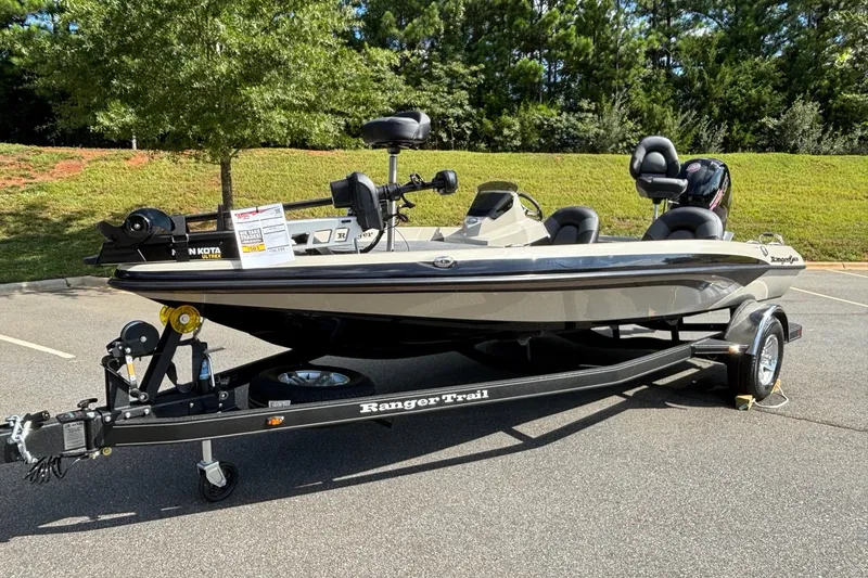 Slide: The Image of 2026 Ranger Z185 boat on trailer in parking lot, surrounded by greenery. - 3