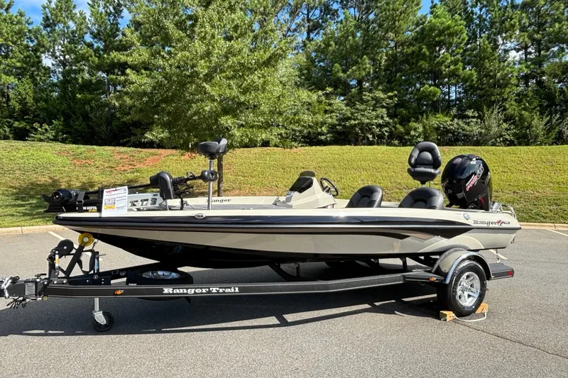 Slide: The Image of 2026 Ranger Z185 boat on trailer, parked outdoors with lush greenery background. - 1
