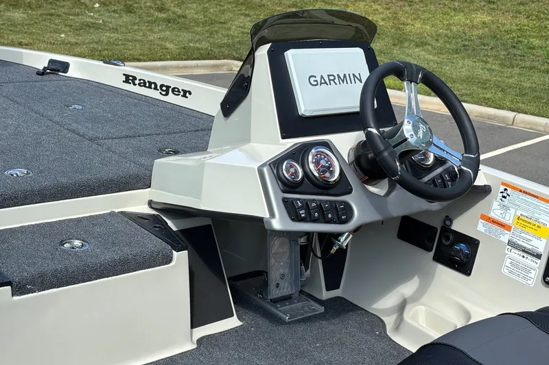 Slide: The Image of 2026 Ranger Z185 boat dashboard with Garmin navigation and steering wheel. - 7