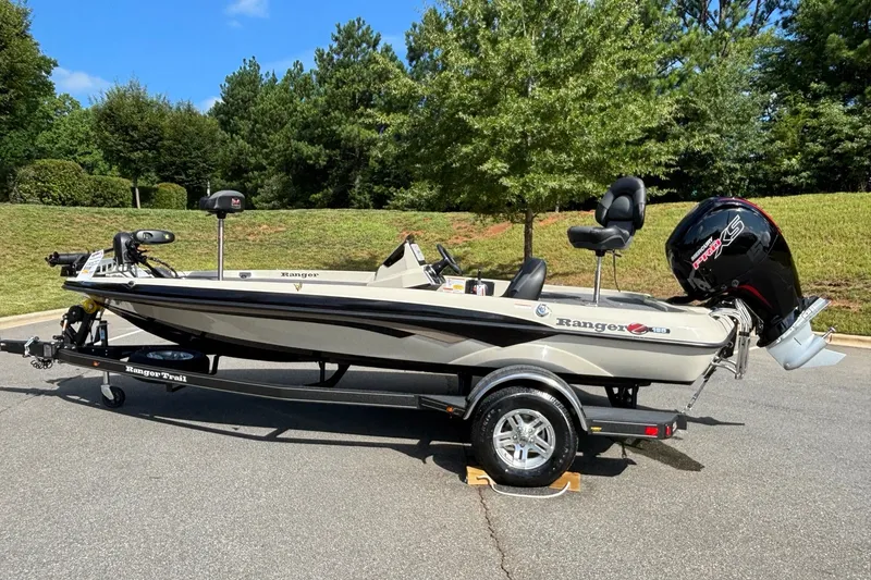 Slide: The Image of 2026 Ranger Z185 boat on trailer, parked outdoors with lush greenery background. - 4