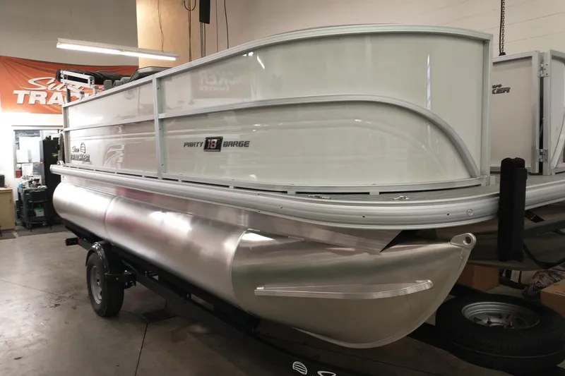 The Image of 2026 Sun Tracker Party Barge 18 DLX pontoon boat in showroom setting. - 0