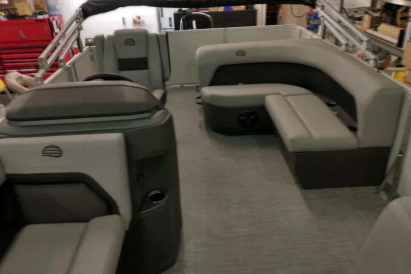 Slide: The Image of 2026 Sun Tracker Party Barge 18 DLX interior with gray seating and modern design. - 3