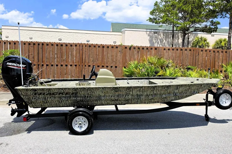 The Image of 2026 Tracker Grizzly 1648 SC boat with camouflage design on a trailer. - 0