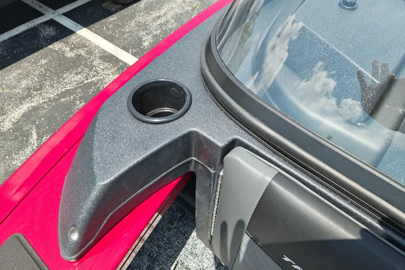 Slide: The Image of 2026 Tracker Targa V-19 Combo boat dashboard with cup holder and windshield detail. - 20