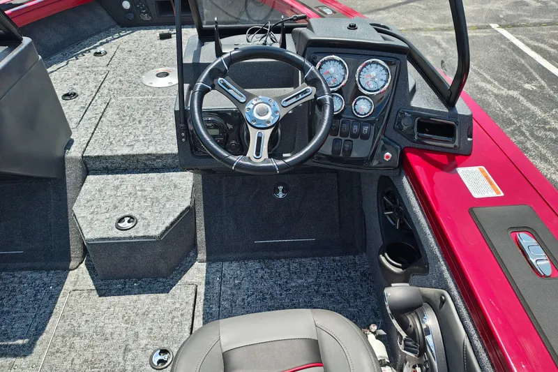 Slide: The Image of 2026 Tracker Targa V-19 Combo boat interior with steering wheel and dashboard controls. - 14