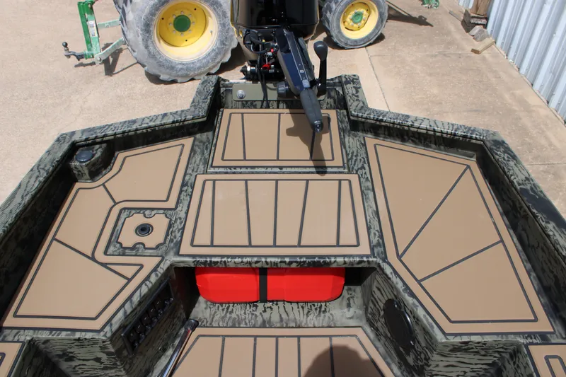 Slide: The Image of 2026 Tracker Grizzly 1650 T Prairie Wings Edition boat interior with camo design and tan flooring. - 5