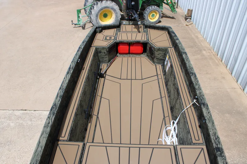 Slide: The Image of 2026 Tracker Grizzly 1650 T Prairie Wings Edition boat interior with camouflage design and spacious layout. - 3