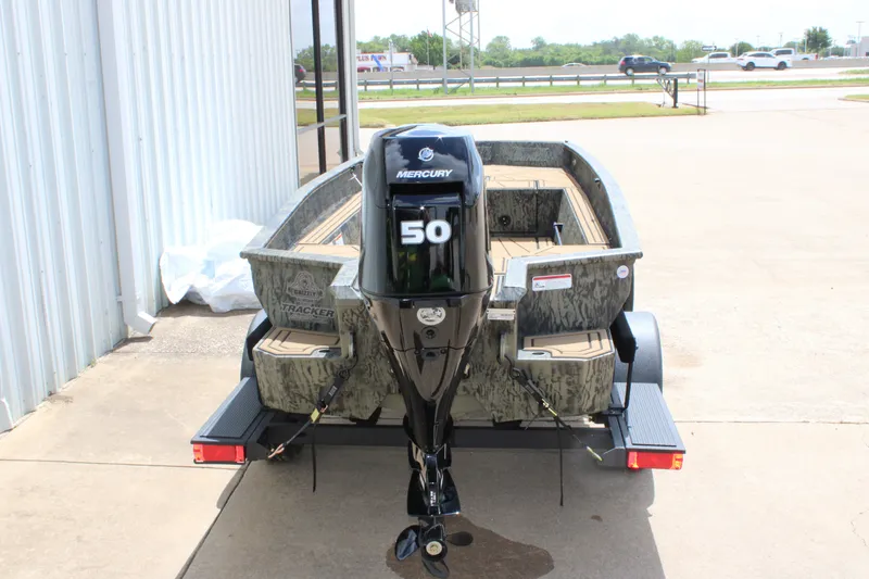 Slide: The Image of 2026 Tracker Grizzly 1650 T Prairie Wings Edition boat with Mercury 50 engine, parked outdoors. - 9
