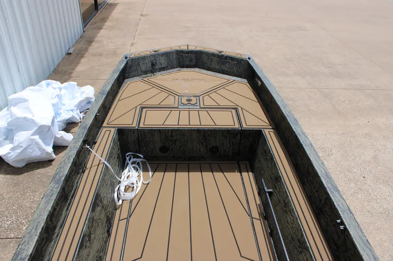 Slide: The Image of 2026 Tracker Grizzly 1650 T Prairie Wings Edition boat interior with camouflage design. - 4