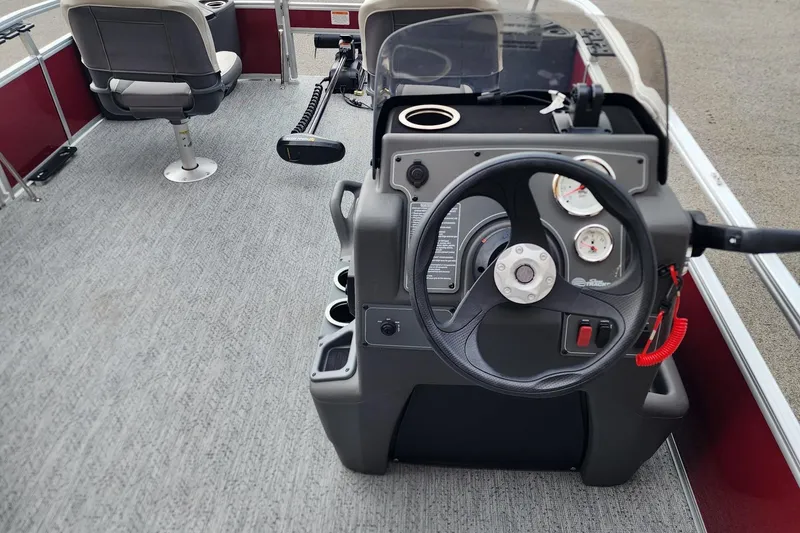 Slide: The Image of 2026 Sun Tracker Bass Buggy 18 DLX boat interior with steering console and seating. - 5