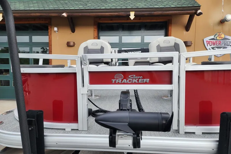 Slide: The Image of 2026 Sun Tracker Bass Buggy 18 DLX pontoon boat with red exterior and seating. - 3