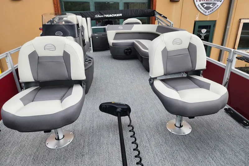 Slide: The Image of 2026 Sun Tracker Bass Buggy 18 DLX pontoon boat interior with plush seating and modern design. - 4