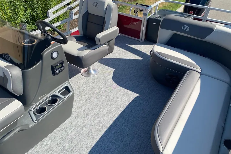 Slide: The Image of 2026 Sun Tracker Bass Buggy 18 DLX interior with seating and steering console. - 6