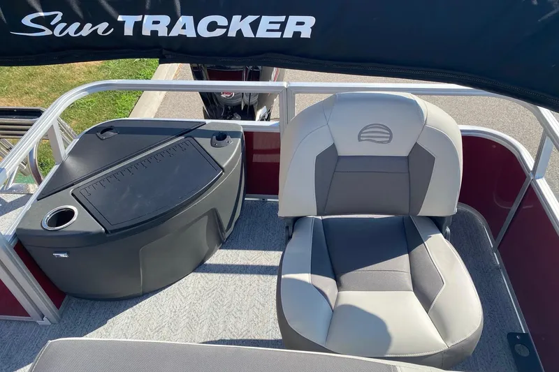 Slide: The Image of 2026 Sun Tracker Bass Buggy 18 DLX pontoon boat interior with seating and console. - 7