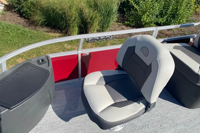 Slide: The Image of 2026 Sun Tracker Bass Buggy 18 DLX boat interior with comfortable seating and red paneling. - 5
