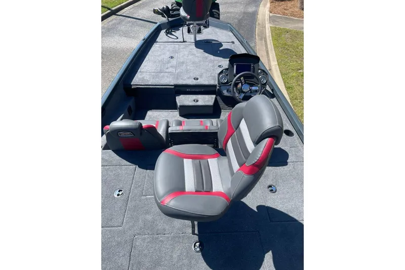 Slide: The Image of 2026 Ranger RT188P boat interior with gray and red seating, steering console, and carpeted deck. - 7