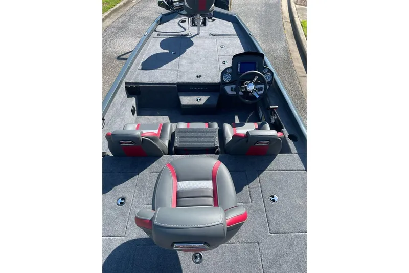 Slide: The Image of 2026 Ranger RT188P boat interior with gray and red seating, steering console, and carpeted deck. - 8