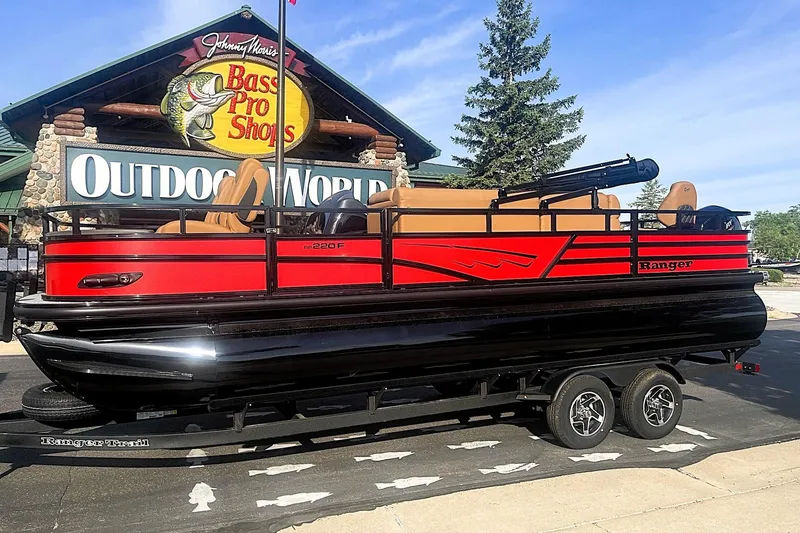 Slide: The Image of 2026 Ranger 220F pontoon boat in front of Bass Pro Shops Outdoor World. - 1