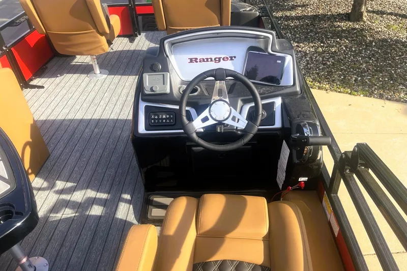 Slide: The Image of 2026 Ranger 220F boat interior with steering wheel and tan seating. - 6