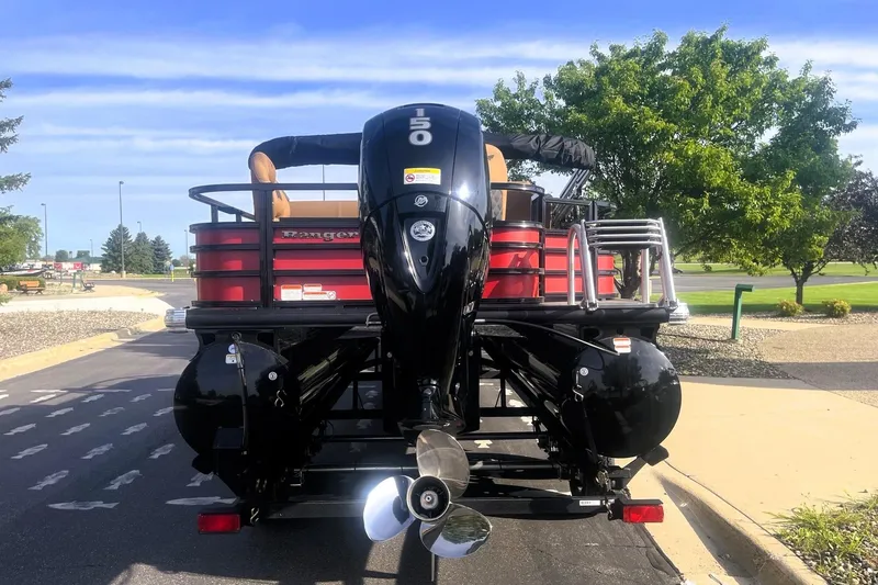 Slide: The Image of 2026 Ranger 220F pontoon boat with powerful outboard motor, parked on a sunny day. - 9