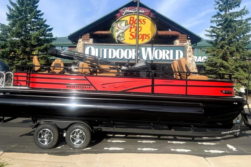 Slide: The Image of 2026 Ranger 220F pontoon boat displayed at Bass Pro Shops Outdoor World. - 2