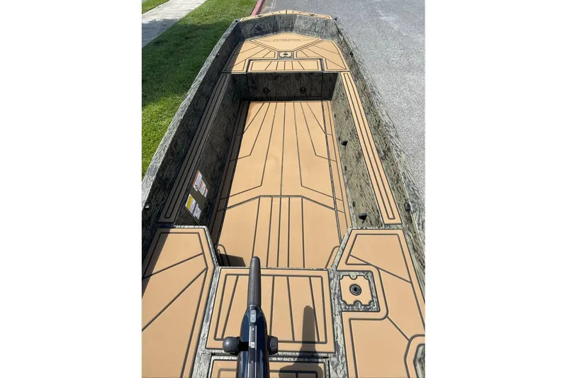 Slide: The Image of 2026 Tracker Grizzly 1650 T Prairie Wings Edition boat interior with tan deck design. - 3