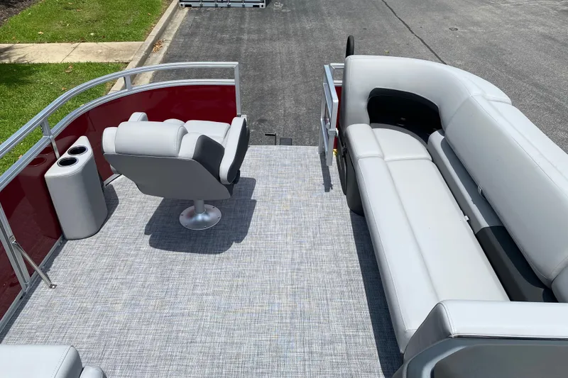 Slide: The Image of 2026 Sun Tracker SportFish 20 DLX pontoon boat interior with seating and cup holders. - 5