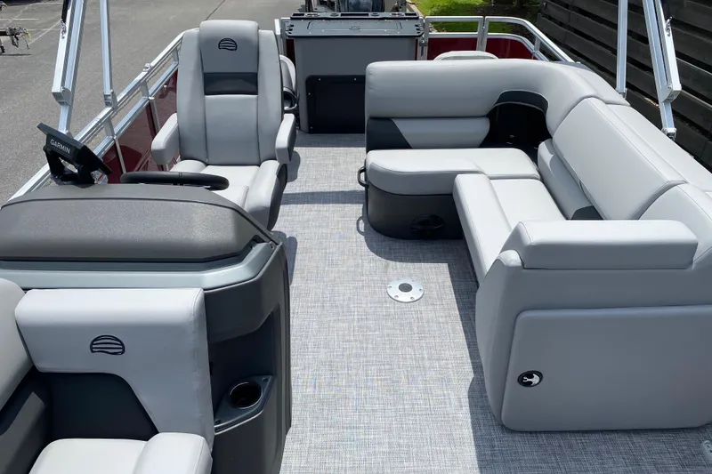 Slide: The Image of 2026 Sun Tracker SportFish 20 DLX pontoon boat interior with gray seating and Garmin navigation. - 93