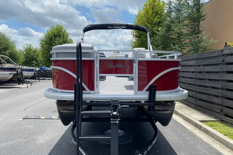 Slide: The Image of 2026 Sun Tracker SportFish 20 DLX pontoon boat on trailer, parked outdoors. - 4