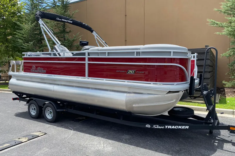 Slide: The Image of 2026 Sun Tracker SportFish 20 DLX pontoon boat on trailer, parked outdoors. - 3