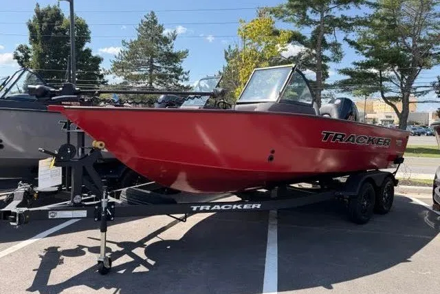 The Image of 2026 Tracker Targa V-18 WT boat in red, parked on a trailer in a lot. - 0