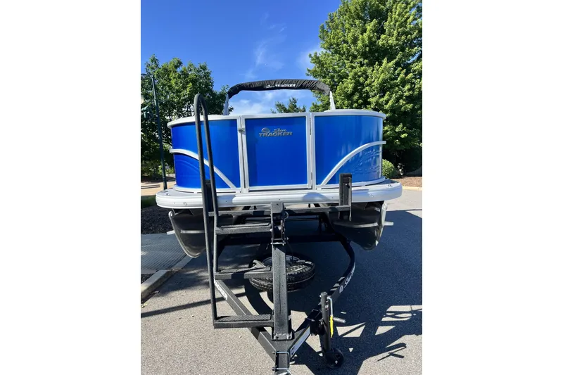 Slide: The Image of 2026 Sun Tracker Party Barge 18 DLX pontoon boat on trailer, parked outdoors. - 5