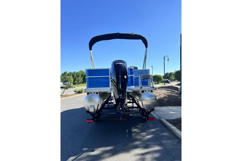 Slide: The Image of 2026 Sun Tracker Party Barge 18 DLX pontoon boat on trailer, rear view. - 74